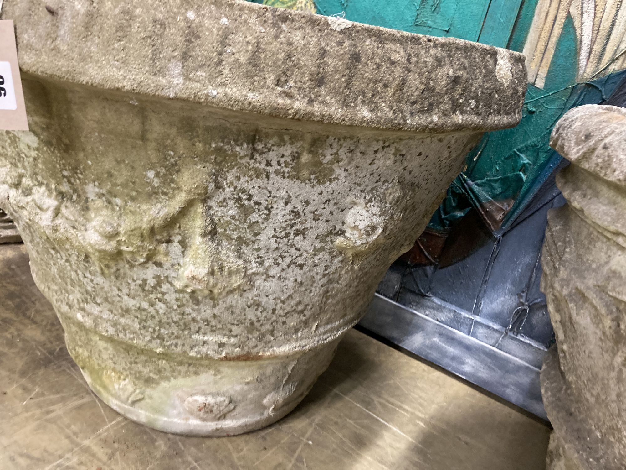 A circular reconstituted stone garden urn, 66cm diameter, height 50cm